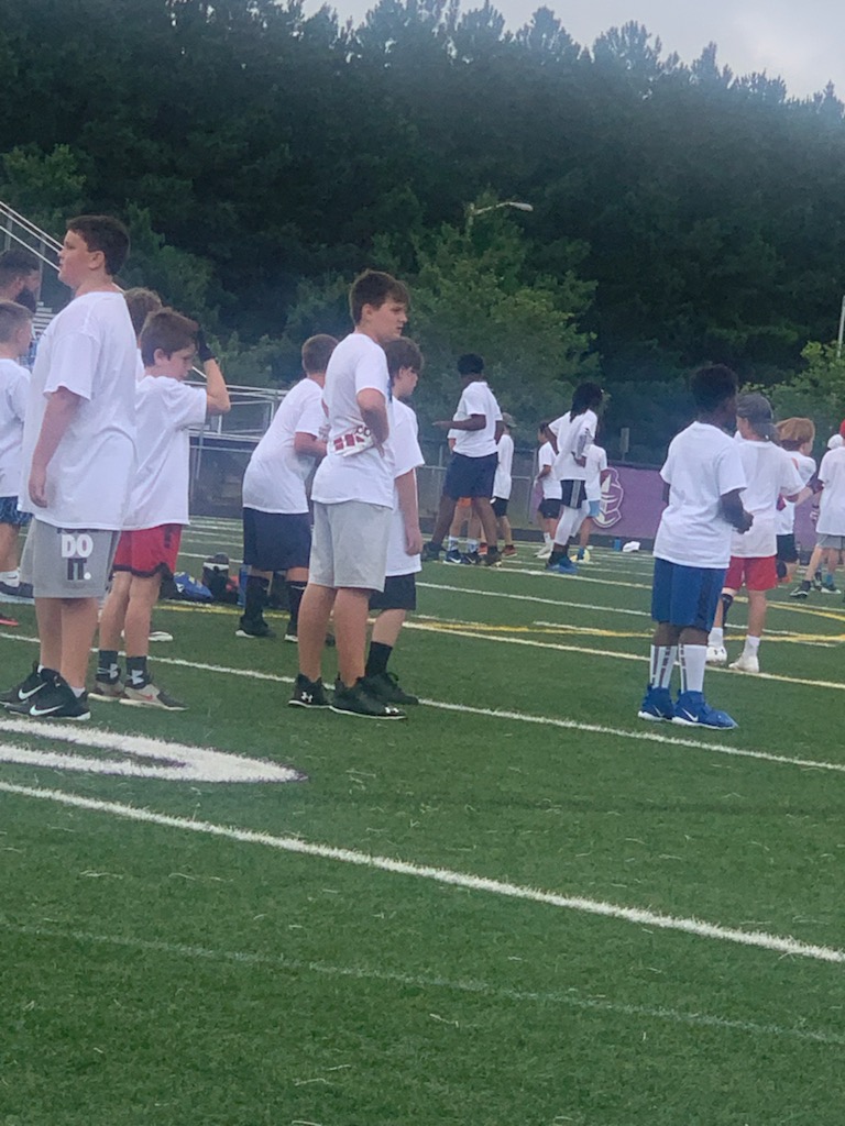 Group of children playing football on a football field