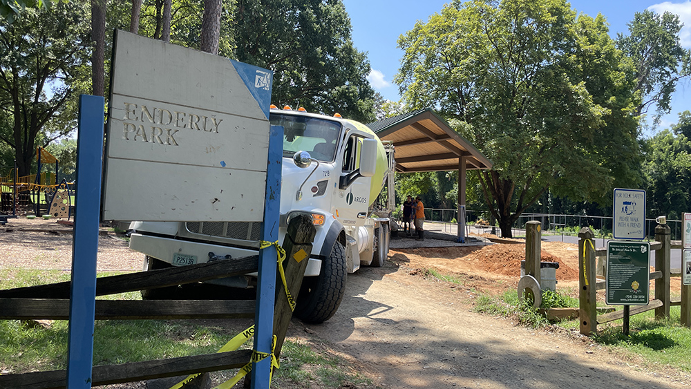 Sign for Enderly Park with a concrete mixer parked behind it