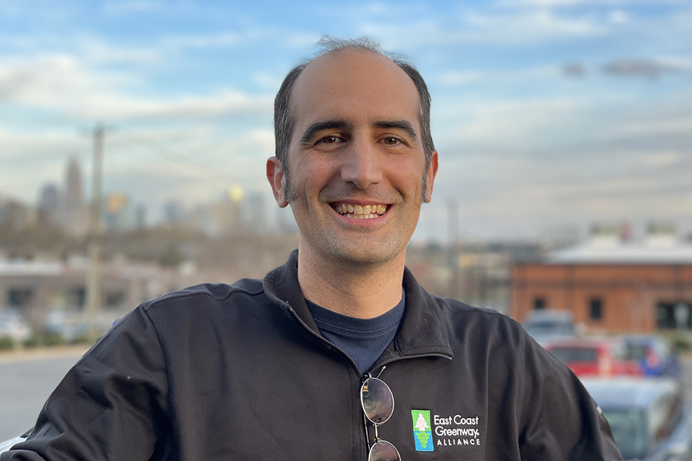 smiling man wearing East Greenway Alliance jacket