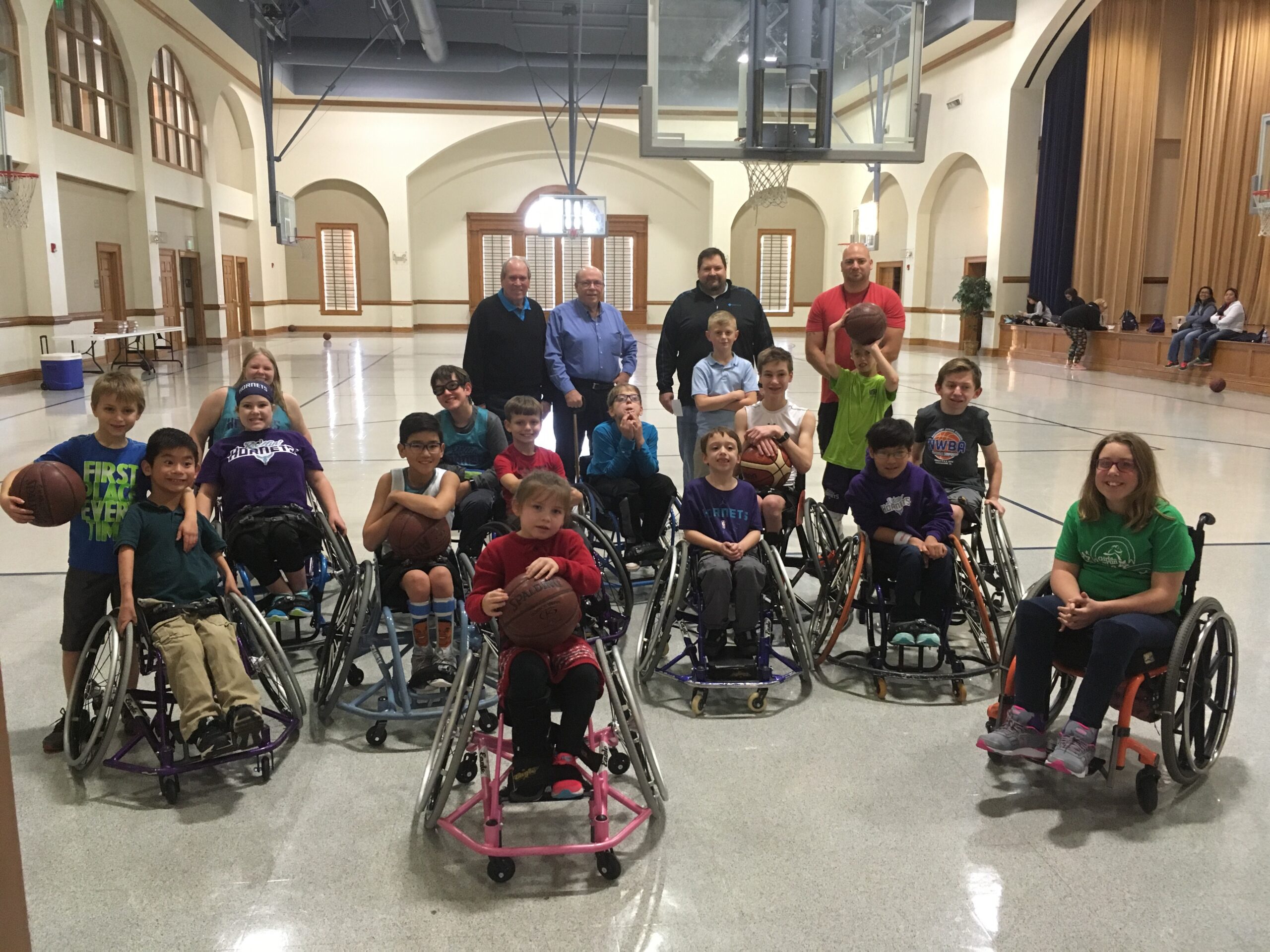 Group of children and coaches for wheelchair basketball
