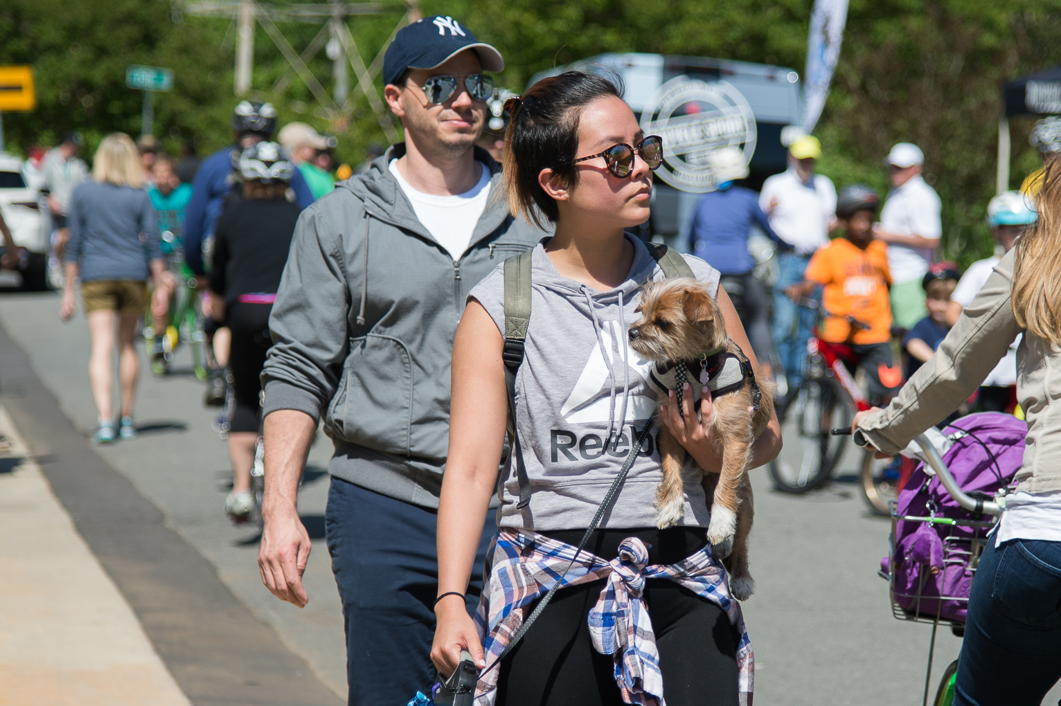 Large group of people walking and biking on a road