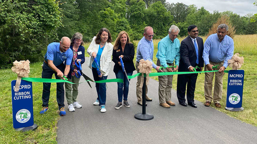 group of people cutting the ribbon at the MCPRD ribbon cutting