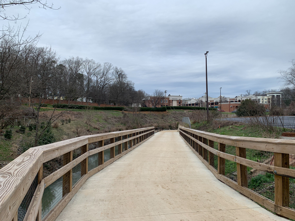 walking bridge with buildings in the background