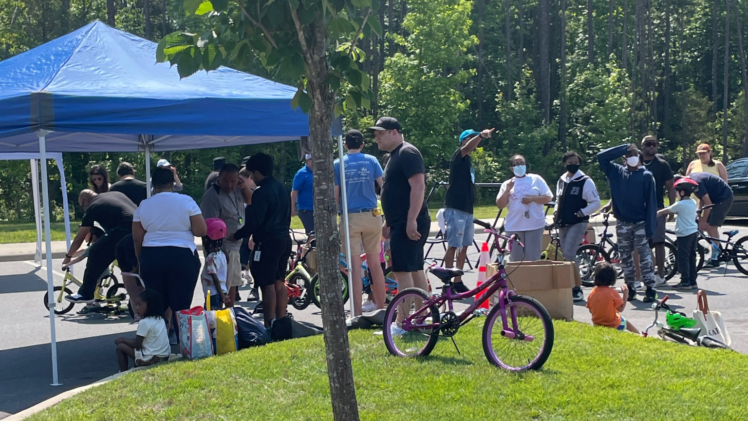 group of people with bicycles near a tent