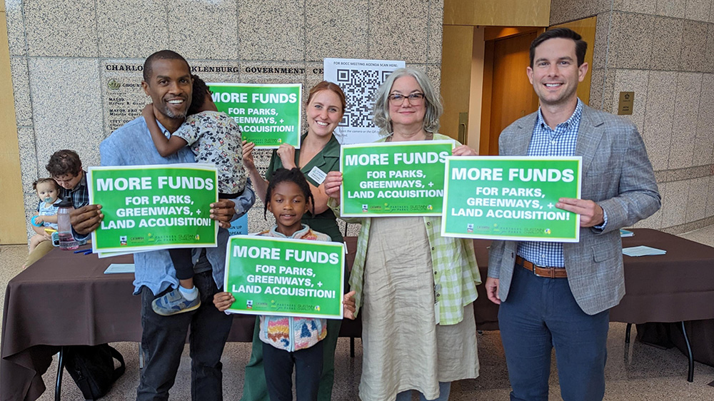 group of people holding signs with text