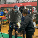 masked people in a shoe store shopping